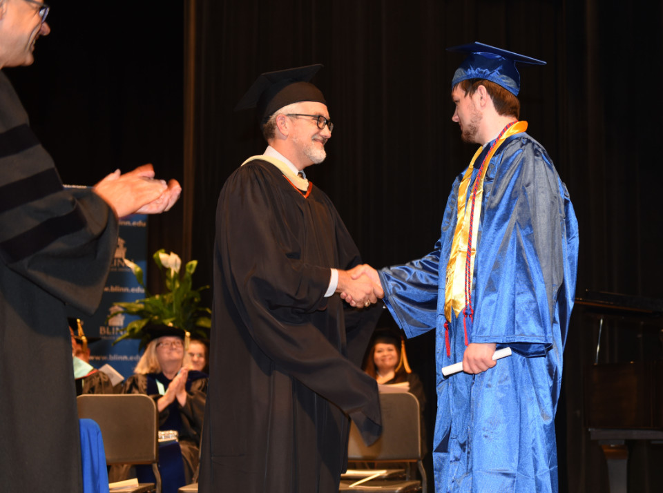 Dean Brandon Franke presented his son Dylan with his graduation scroll