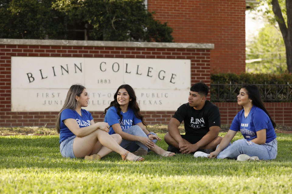 Group of Blinn College chatting on campus lawn area