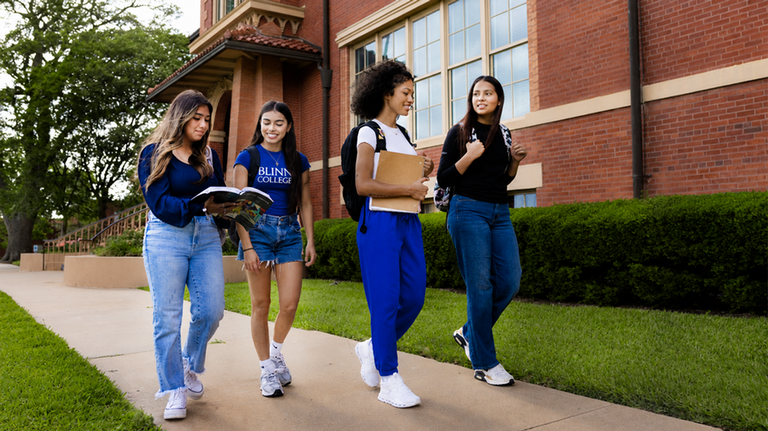 Three Students In Front of Old Main Building